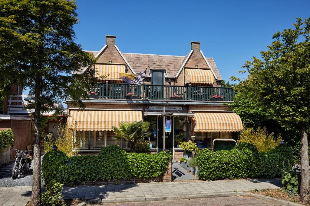 a large house with a balcony on top of it at Guest House Aquarius in Zandvoort