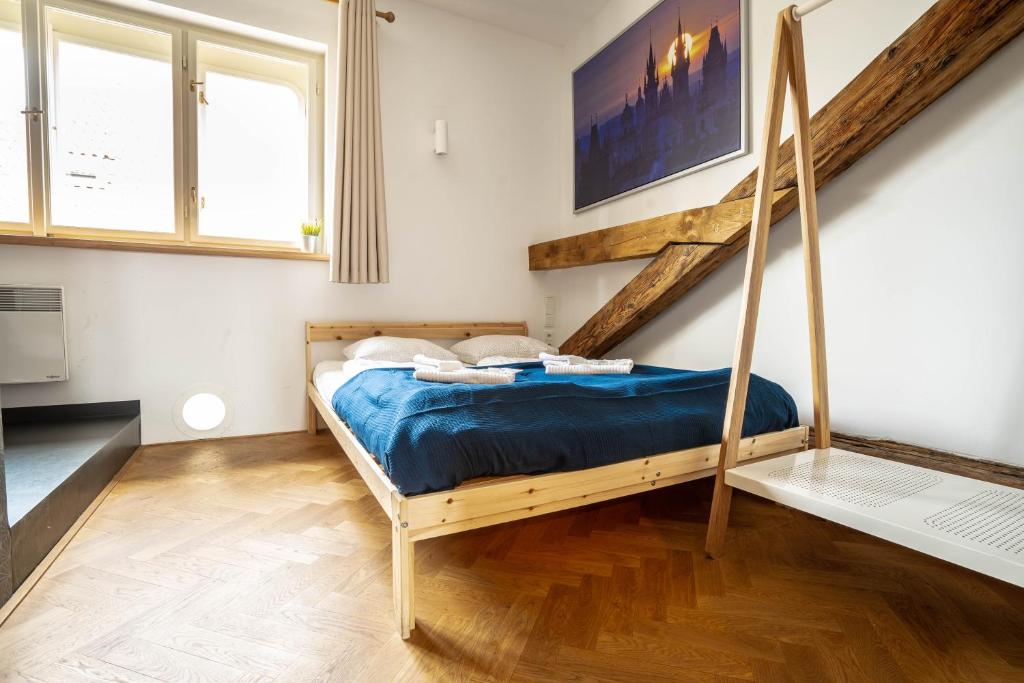 a bedroom with a bed with a wooden bed frame at Old Town Square Suites Prague in Prague