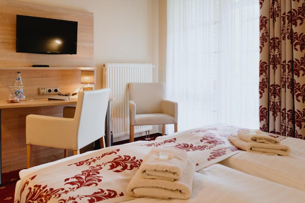 Postel nebo postele na pokoji v ubytování Hotel An den Bleichen