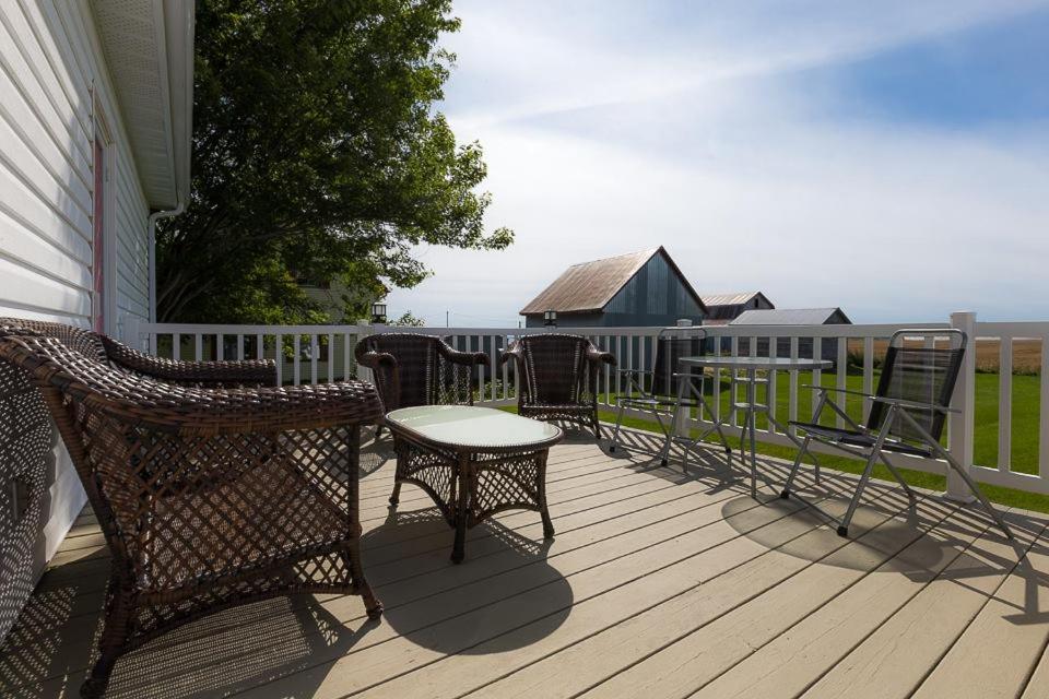 a patio with chairs and a table on a deck at Les Gites Makadan in Normandin