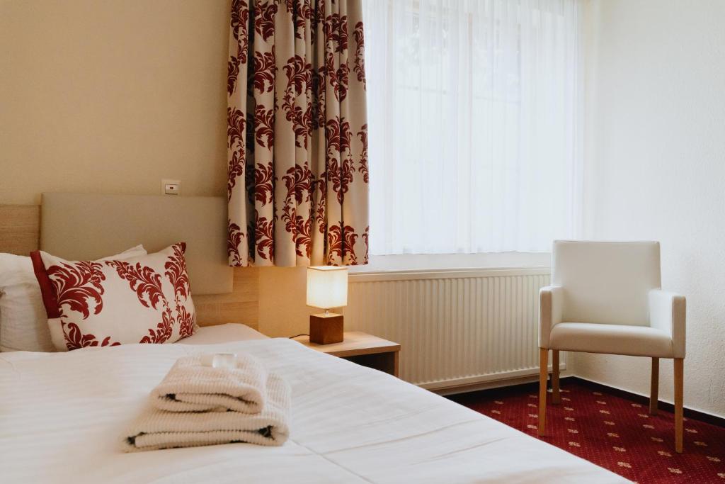Postel nebo postele na pokoji v ubytování Hotel An den Bleichen