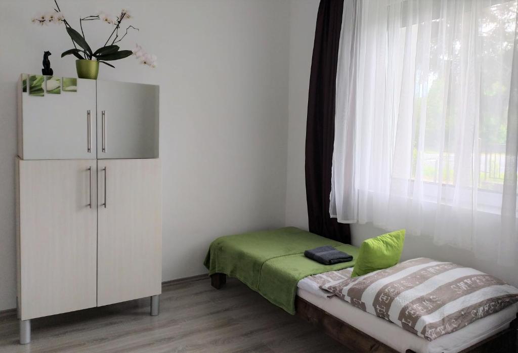 Łóżko lub łóżka w pokoju w obiekcie Elizabeth Vendégház Balatonfűzfőn a Strandnál