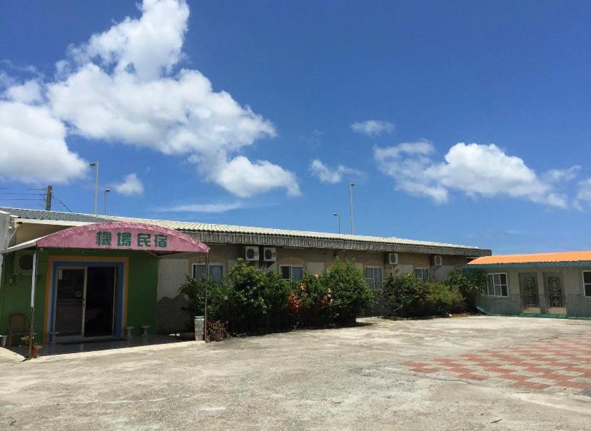 a building with a parking lot in front of it at Kenting Airport Homestay 機場民宿 in Hengchun South Gate