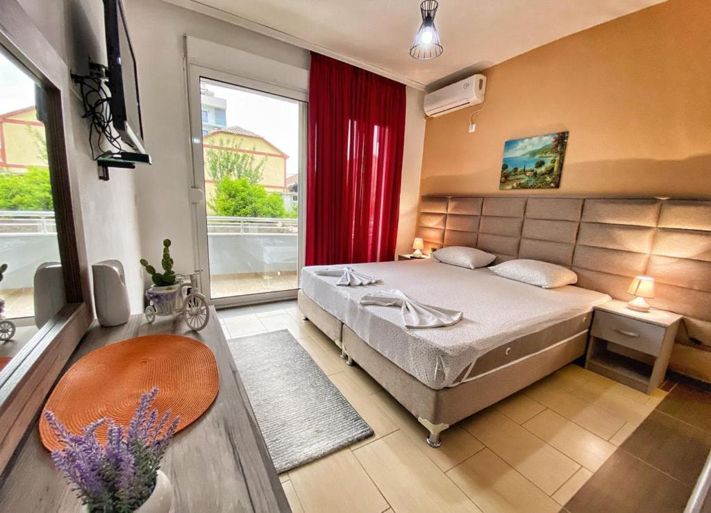 a bedroom with a bed and a large window at MD APARTMENTS in Ulcinj