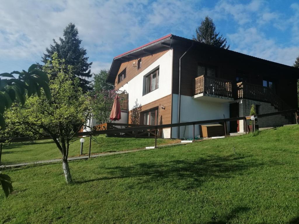 a large house with a grassy yard in front of it at Chata Panorama Beskidów in Ustroń