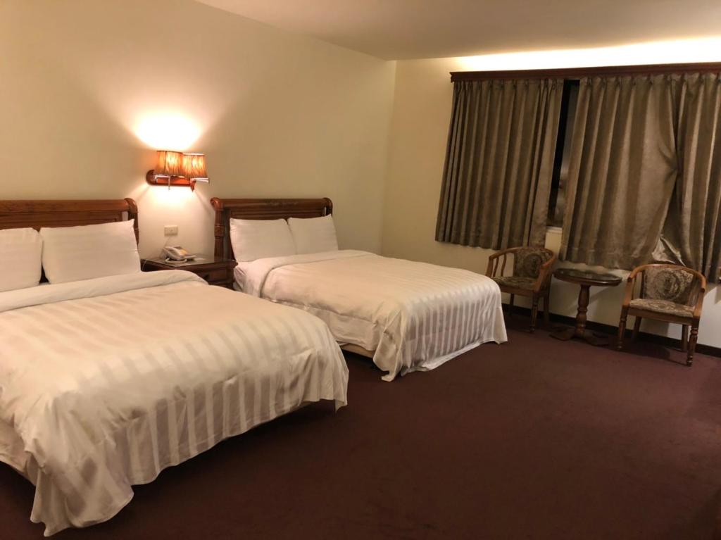 Postel nebo postele na pokoji v ubytování England Business Motel