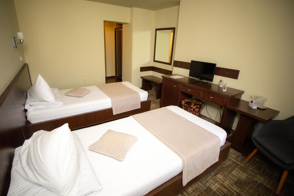 Postel nebo postele na pokoji v ubytování Hotel Select Slobozia