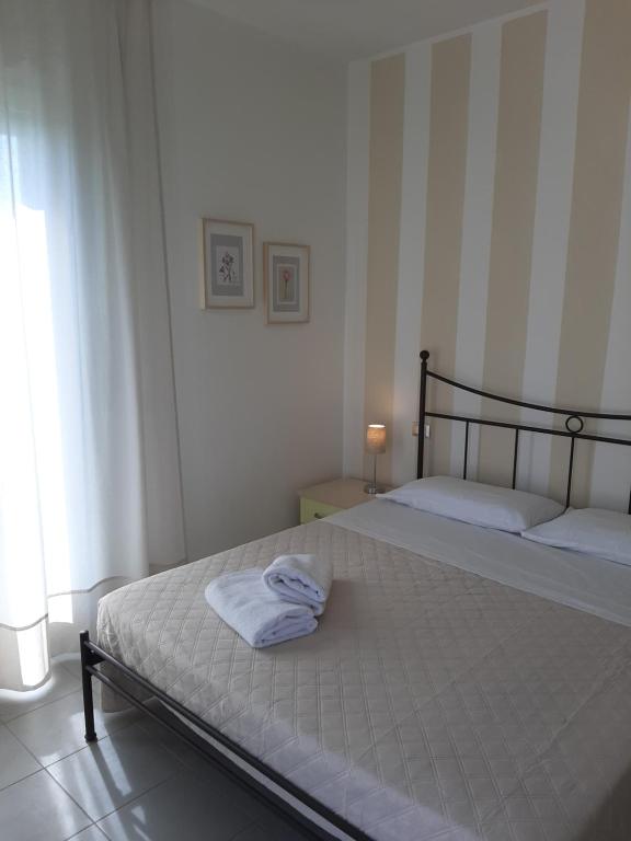 um quarto com uma cama com uma toalha em Casa VerdeMare em Porto Recanati