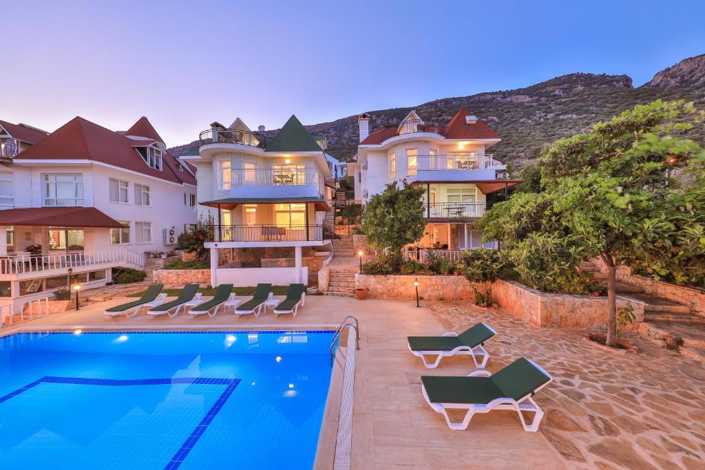 a large house with a swimming pool in front of it at 3 House Apart in Kas