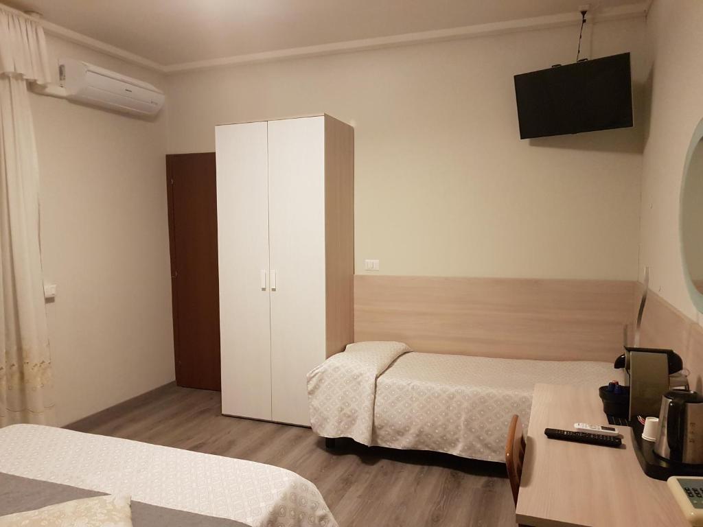 Postel nebo postele na pokoji v ubytování Albergo Paradiso