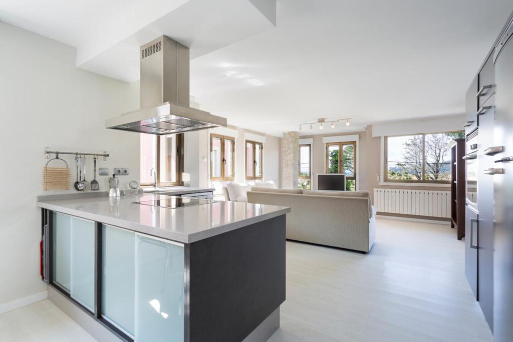 a kitchen with a large island in the middle at Housingcoruña Apartamento Playa Miño 03 in Miño