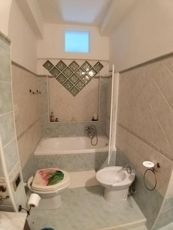 W łazience znajduje się toaleta, wanna i umywalka. w obiekcie B & B Arco di Sole w mieście Pontecagnano