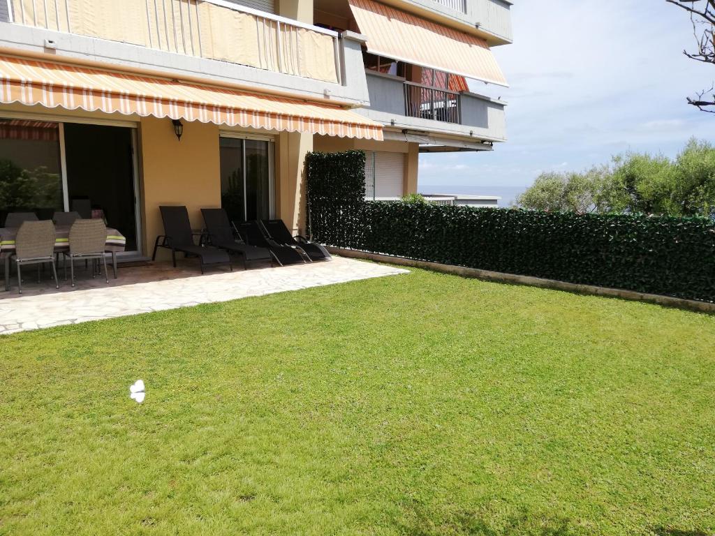 a piece of paper sitting on the grass in front of a building at Appartement Le Belvédère in Roquebrune-Cap-Martin
