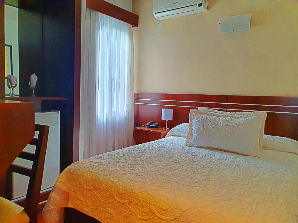 Postel nebo postele na pokoji v ubytování Hotel America