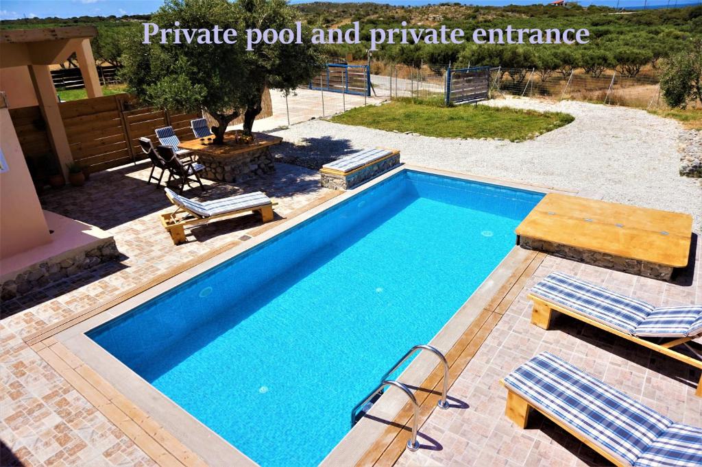 a pool with two chairs and a picnic pool and private entrance at Sea Lake Holiday House in Elafonisi