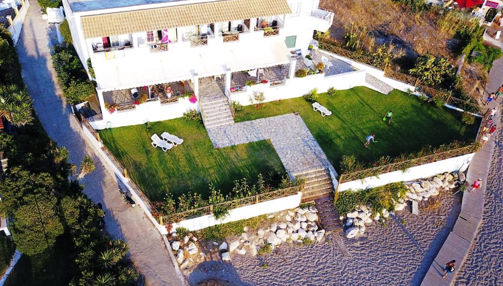 an overhead view of a white building with a yard at Nereides Apartments in Agios Gordios