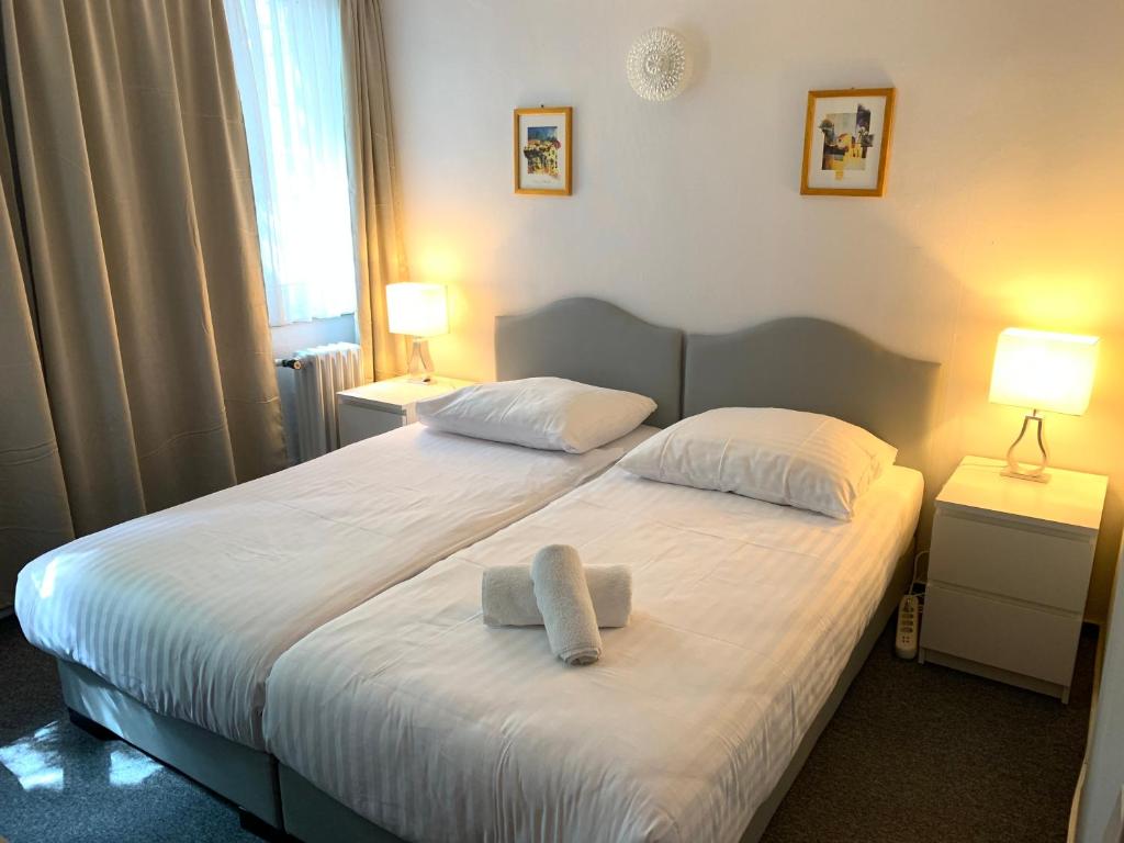 um quarto com uma cama com duas toalhas em Hotel Berg em Colônia