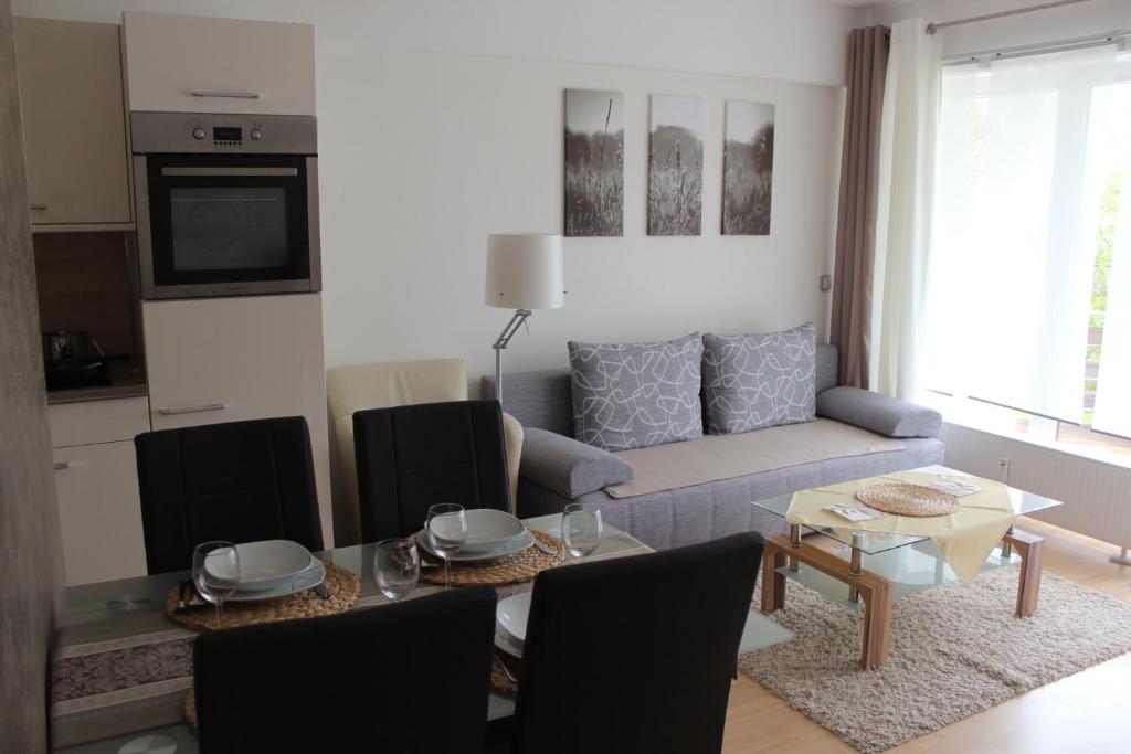 a living room with a couch and a table at Ferienwohnung Mohnwiese und Blumenwiese in Willingen