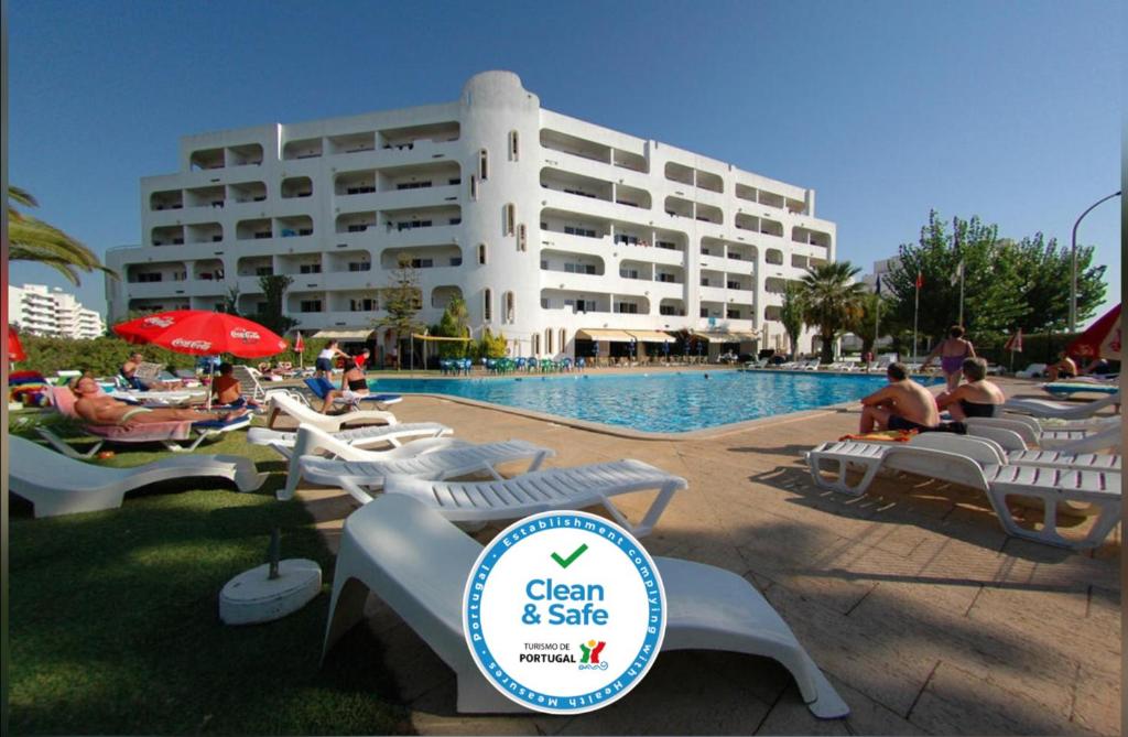 a resort with a swimming pool and a building at Apartamentos Turisticos Silchoro in Albufeira