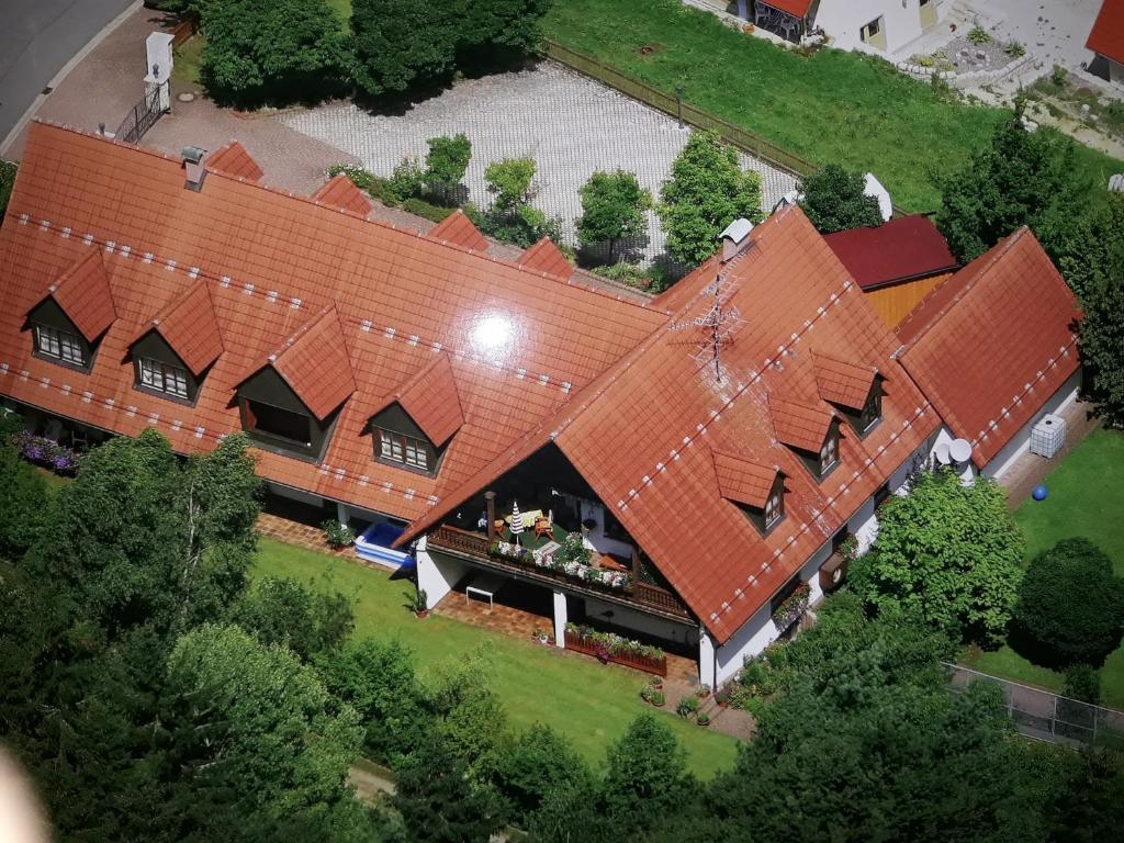 an overhead view of a large house with orange roofs at Ferienwohnung/ Ferienresidenze Manuela in Obertrubach