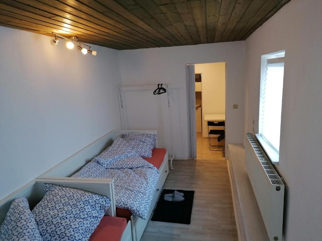 a small room with two beds and a hallway at Jasmin in Laichingen