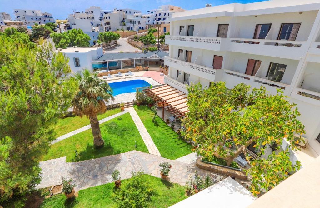 an aerial view of a building with a swimming pool and trees at Aeolos Bay Tinos in Tinos Town