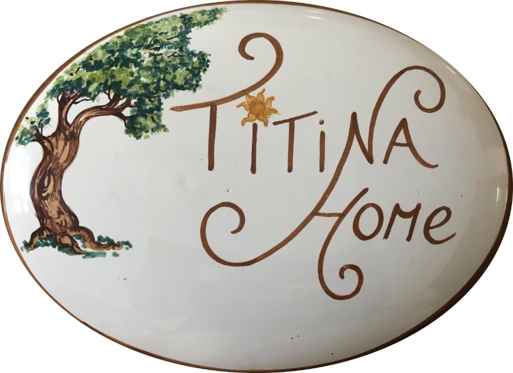 a plate with a tree and the words titina home at Casa Vacanze TITINA HOME in Montalbano