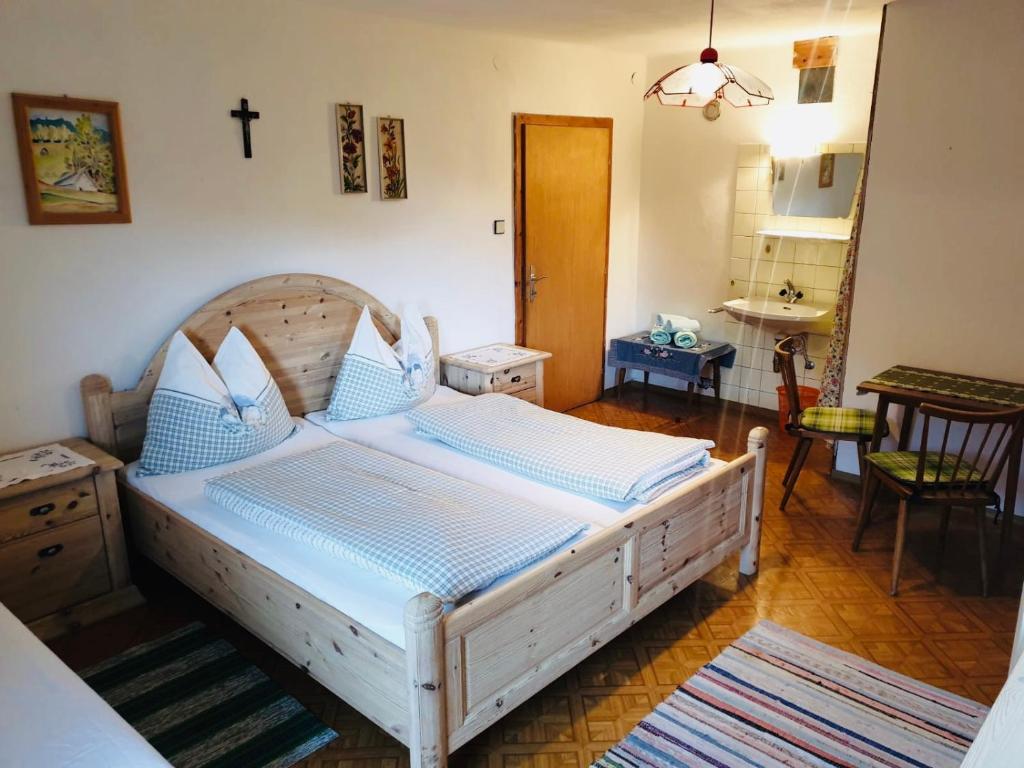a bedroom with a bed with a cross on the wall at Zauneralm in Aich