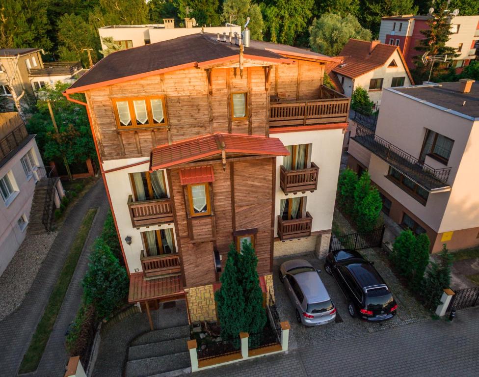 an aerial view of a house with cars parked in front at Willa Bursztynowa 13 in Gdańsk