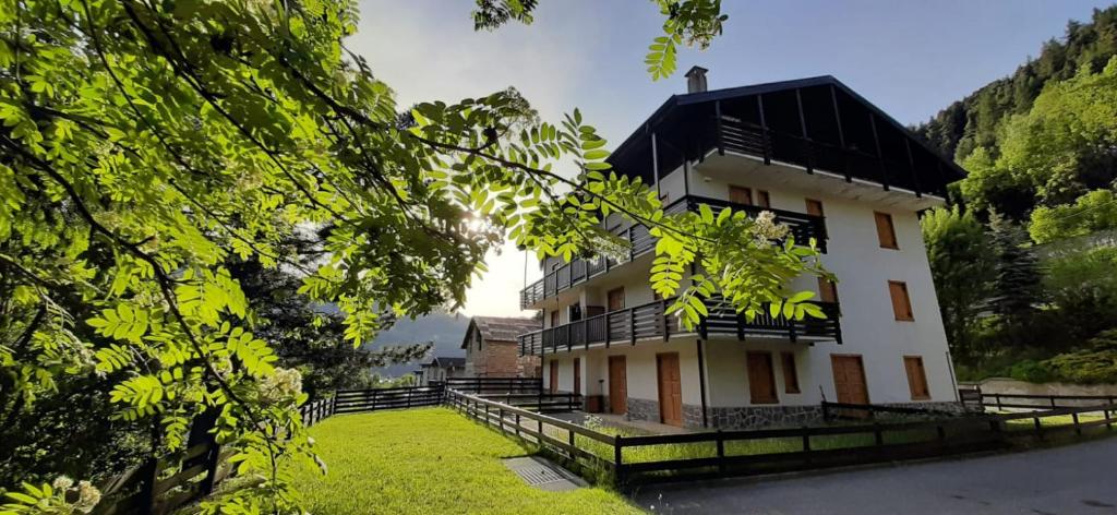 a large white building with a black roof at Residenza Capinera in Bormio