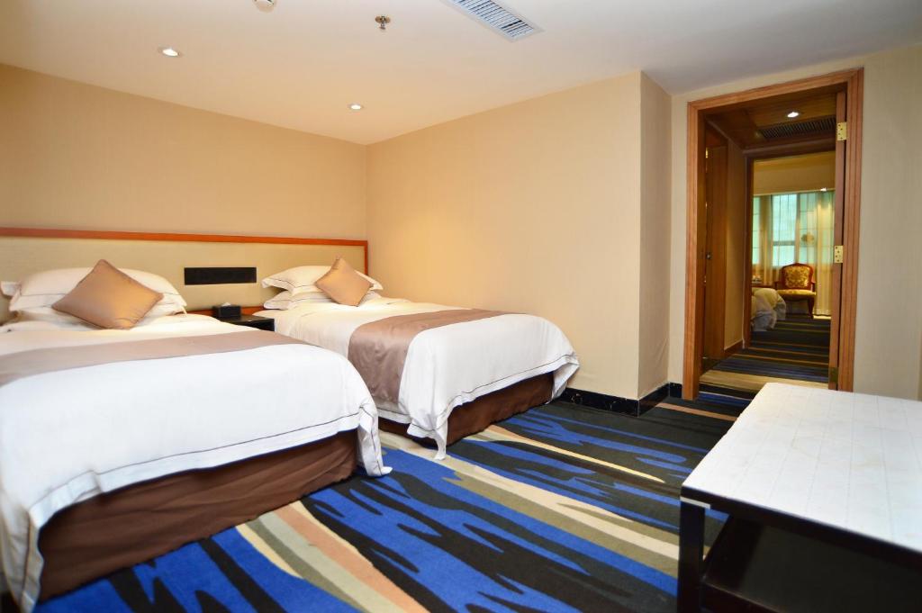 Postel nebo postele na pokoji v ubytování Shenzhen Kaili Hotel, Guomao Shopping Mall