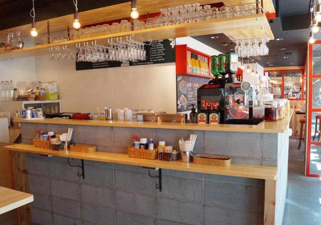 a bar in a restaurant with a counter with drinks at APA Hotel Akihabara Ekimae in Tokyo