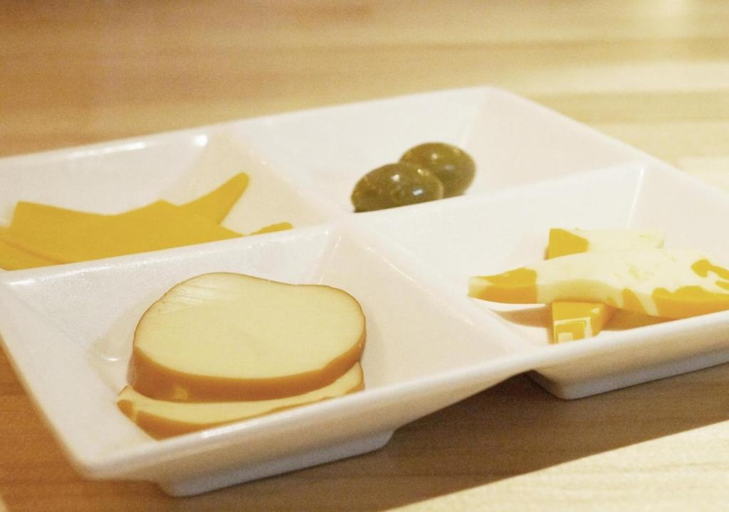 a plastic container with cheese and other foods in it at APA Hotel Akihabara Ekimae in Tokyo