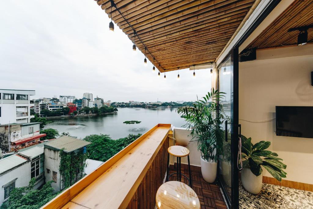 a balcony with a view of a river at The Autumn Homestel in Hanoi