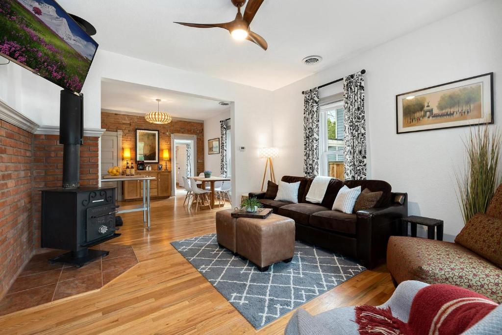 a living room with a couch and a fireplace at Lola House! Cozy Comfort, Prime Old Town Location in Fort Collins