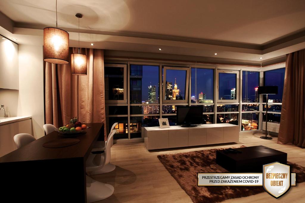 a living room with a view of a city skyline at Platinum Residence in Warsaw