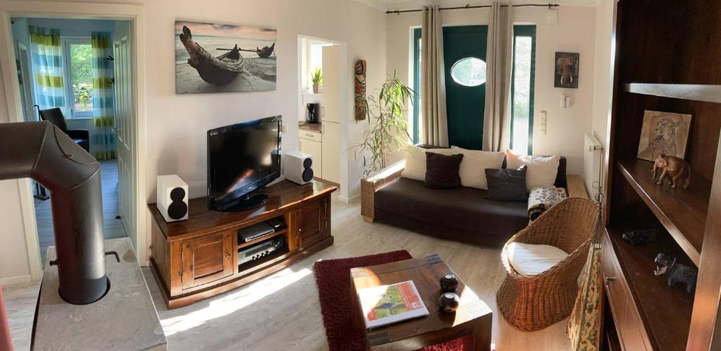 a living room with a television and a couch at Hoeperhof in Bötersen