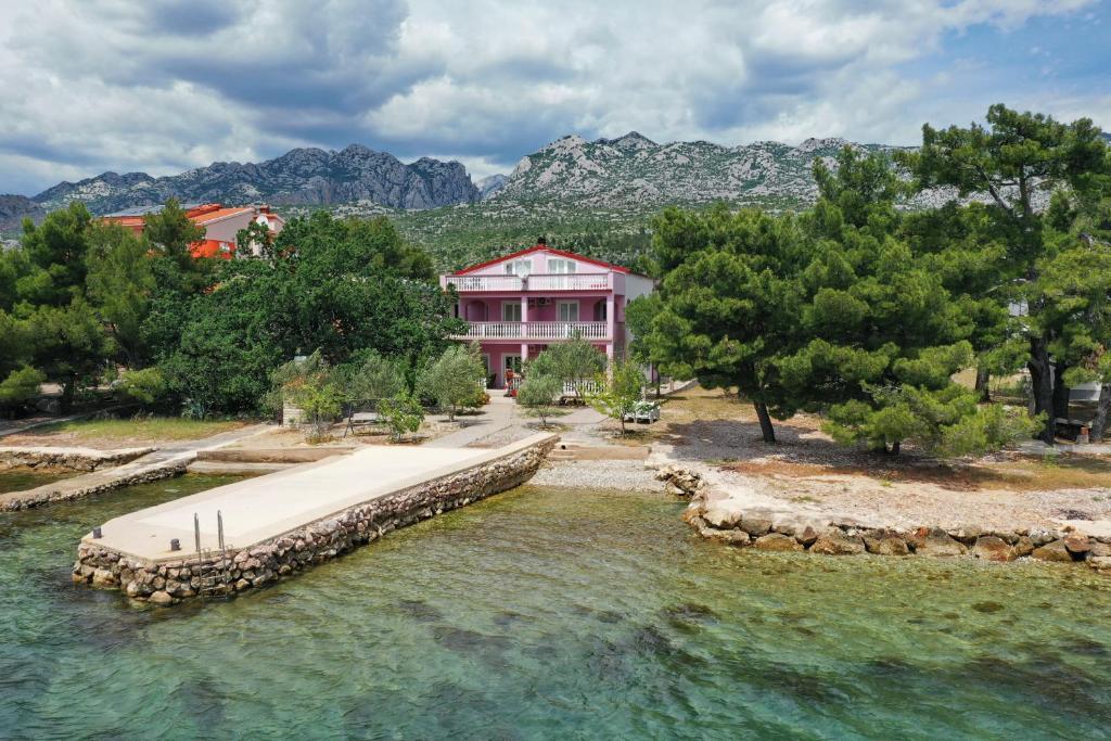 an aerial view of a house with a dock in the water at Villa Rajna in Starigrad