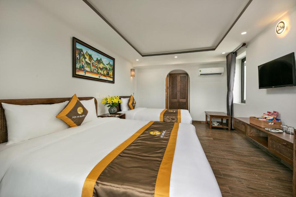 Postel nebo postele na pokoji v ubytování Villa Blake Hoi An