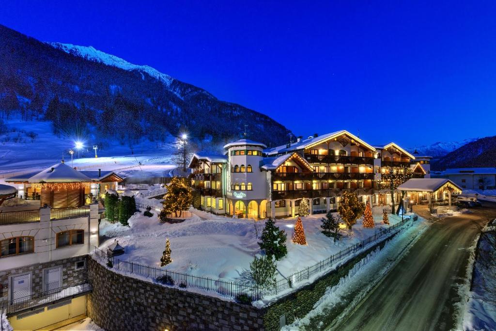 ośrodek wypoczynkowy w górach ze śniegiem na ziemi w obiekcie Kristiania Pure Nature Hotel & Spa w mieście Cogolo