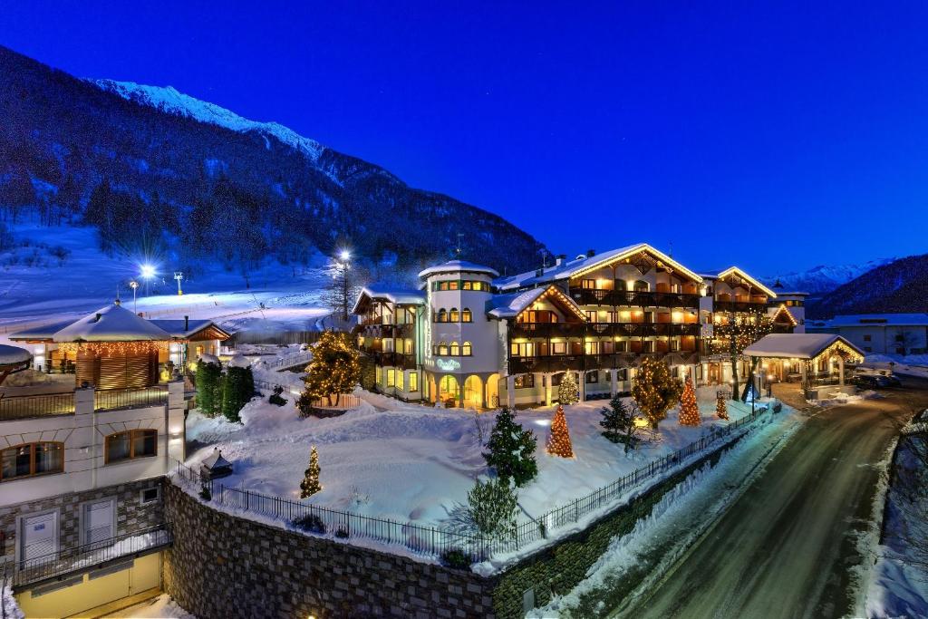 a resort in the mountains with snow on the ground at Kristiania Pure Nature Hotel & Spa in Cogolo