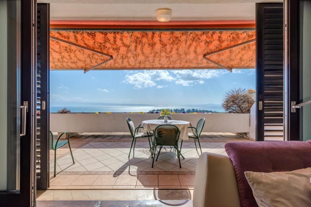 a room with a table and chairs on a patio at Apartments Marjan in Split