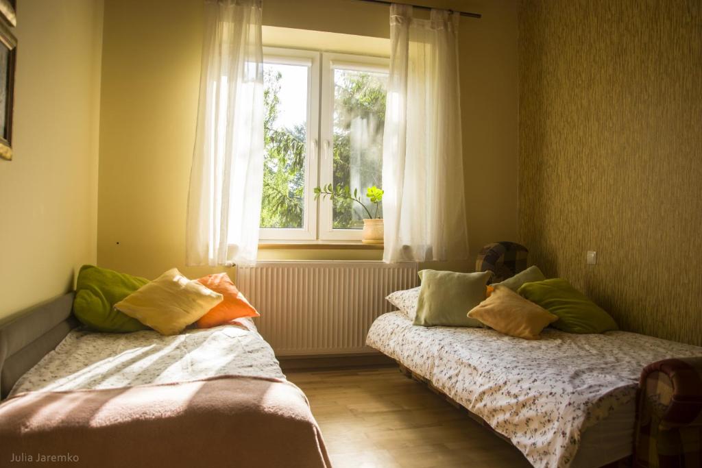 Postel nebo postele na pokoji v ubytování Leśne Zacisze
