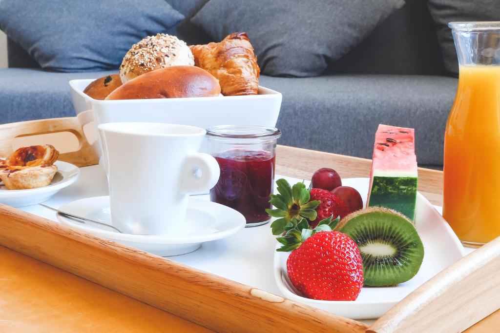 a tray of breakfast food on a coffee table at Hotel Praia in Nazaré