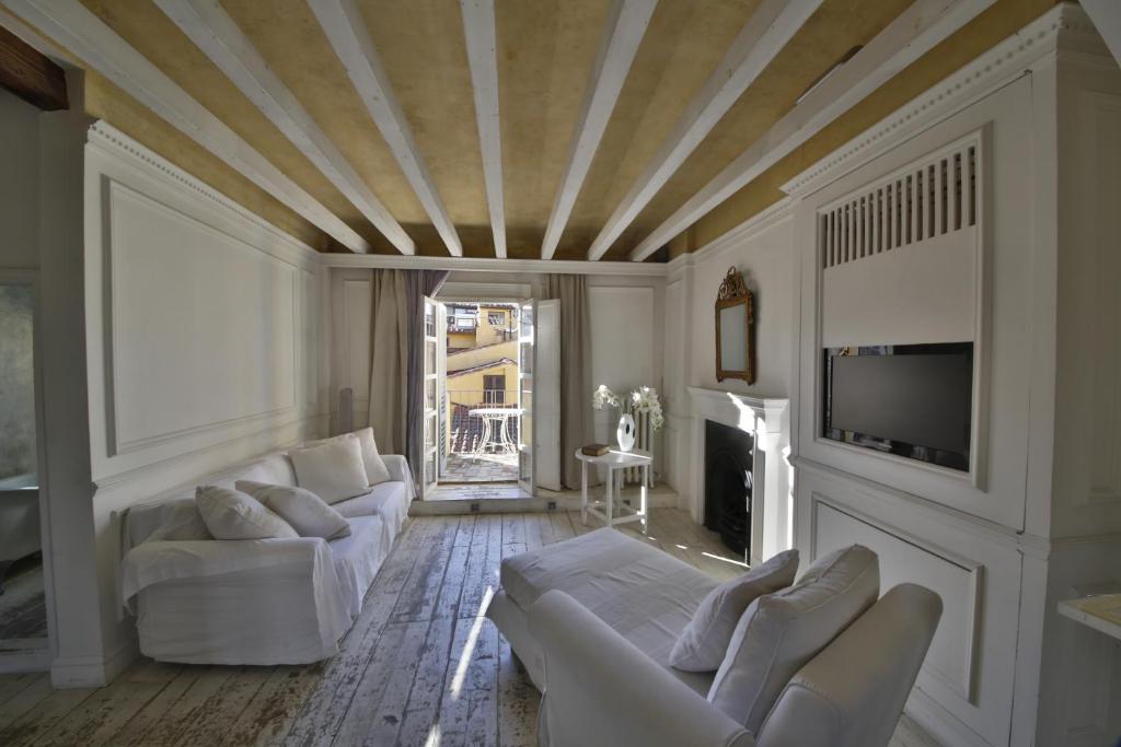 a living room with white furniture and a coffered ceiling at White Home in Florence