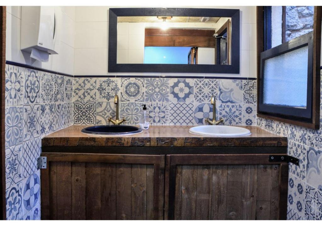 Un baño con dos lavabos y un espejo. en L'Hostalet de Canet, en Canet de Mar