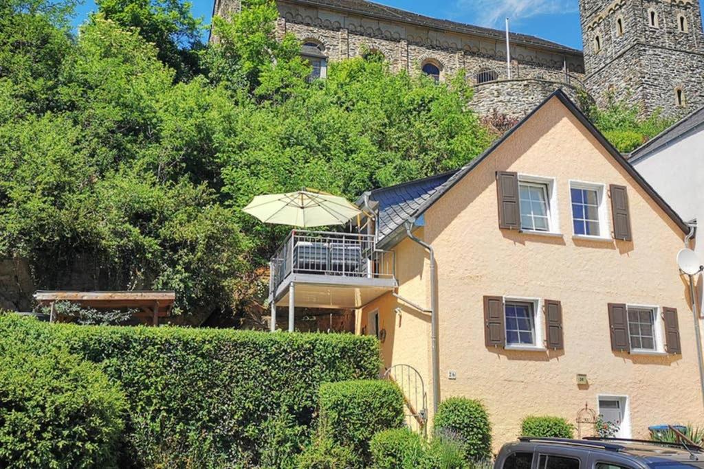 a house with an umbrella in front of it at Haus Sonnenschein in Bad Bertrich