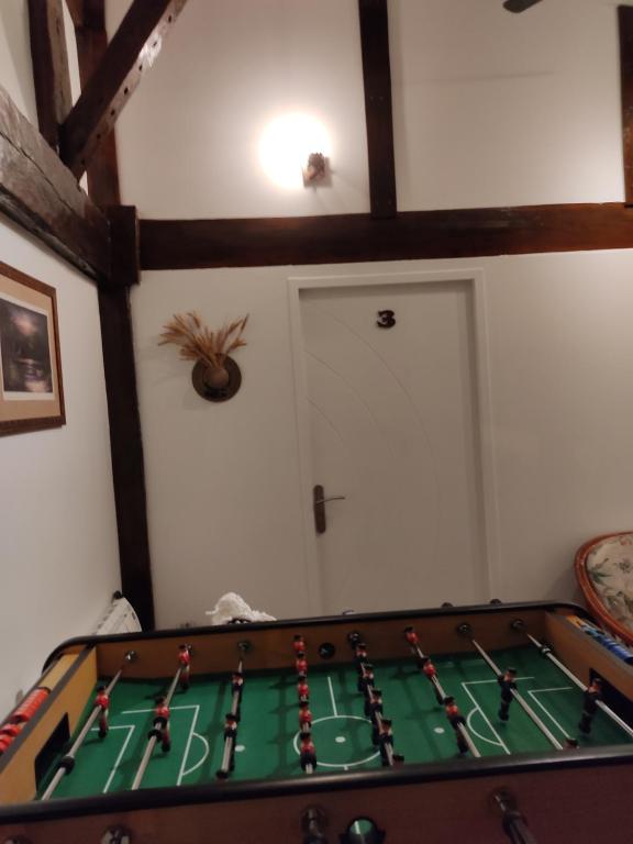 a ping pong table in a living room with at Le Deroscope in Arrigny