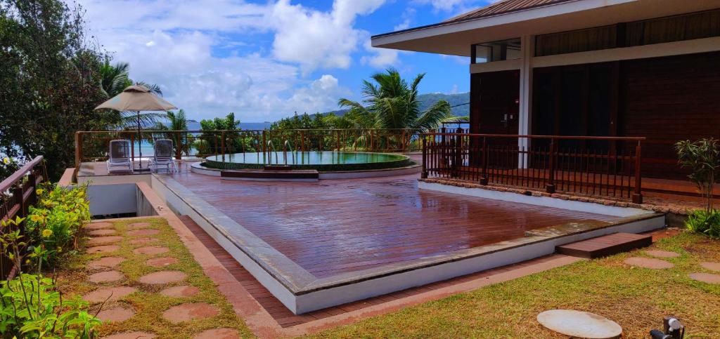 a patio with a swimming pool on a house at Le Relax Luxury Lodge in La Digue