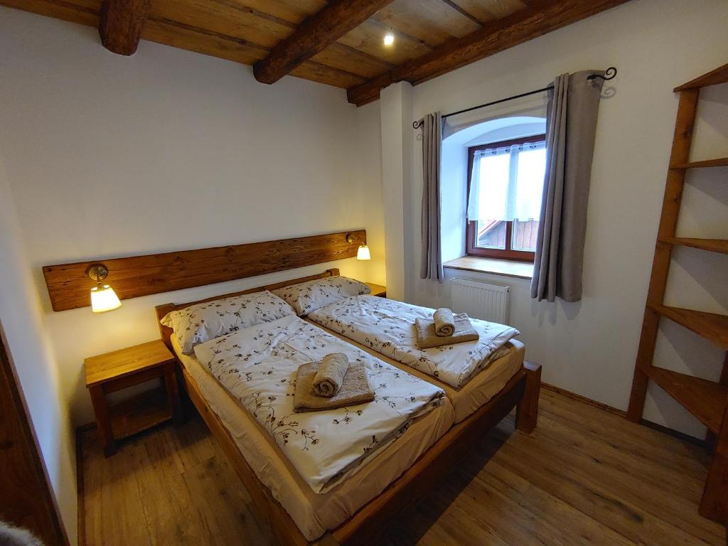 a bedroom with a bed with two hats on it at U Mikešů in Vyšší Brod